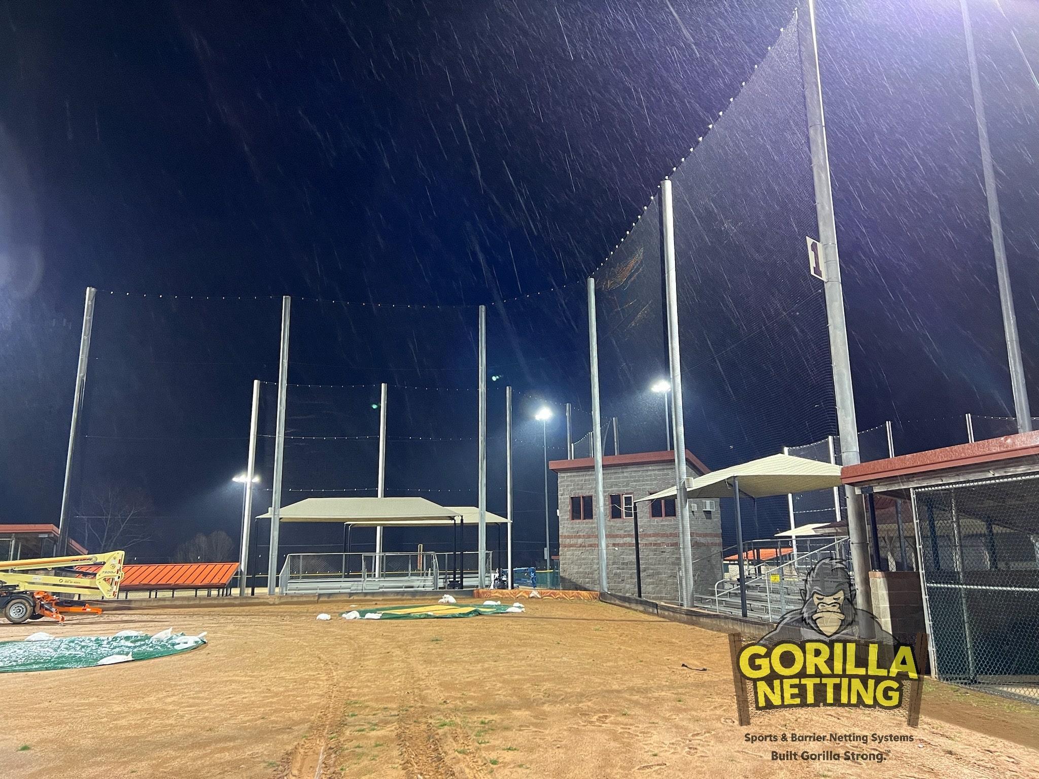 Overhead and perimeter sports field netting protecting spectators at a multi-sport facility