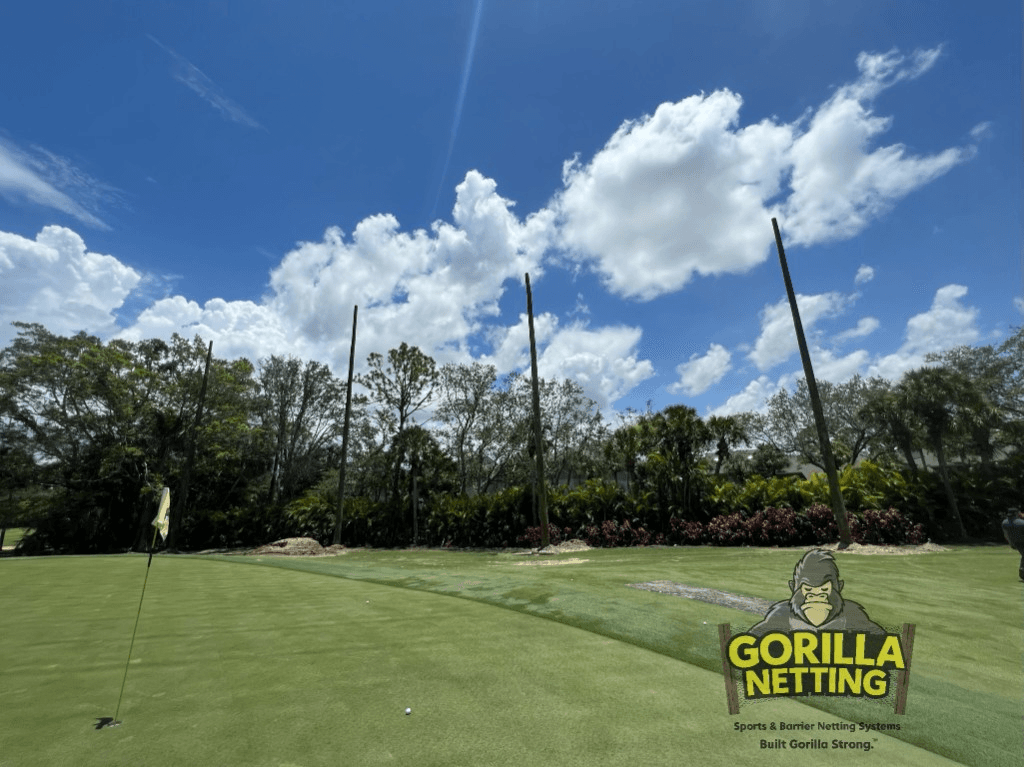 Golf course barrier netting support poles along the fairway at Eagle Creek Golf and Country Club